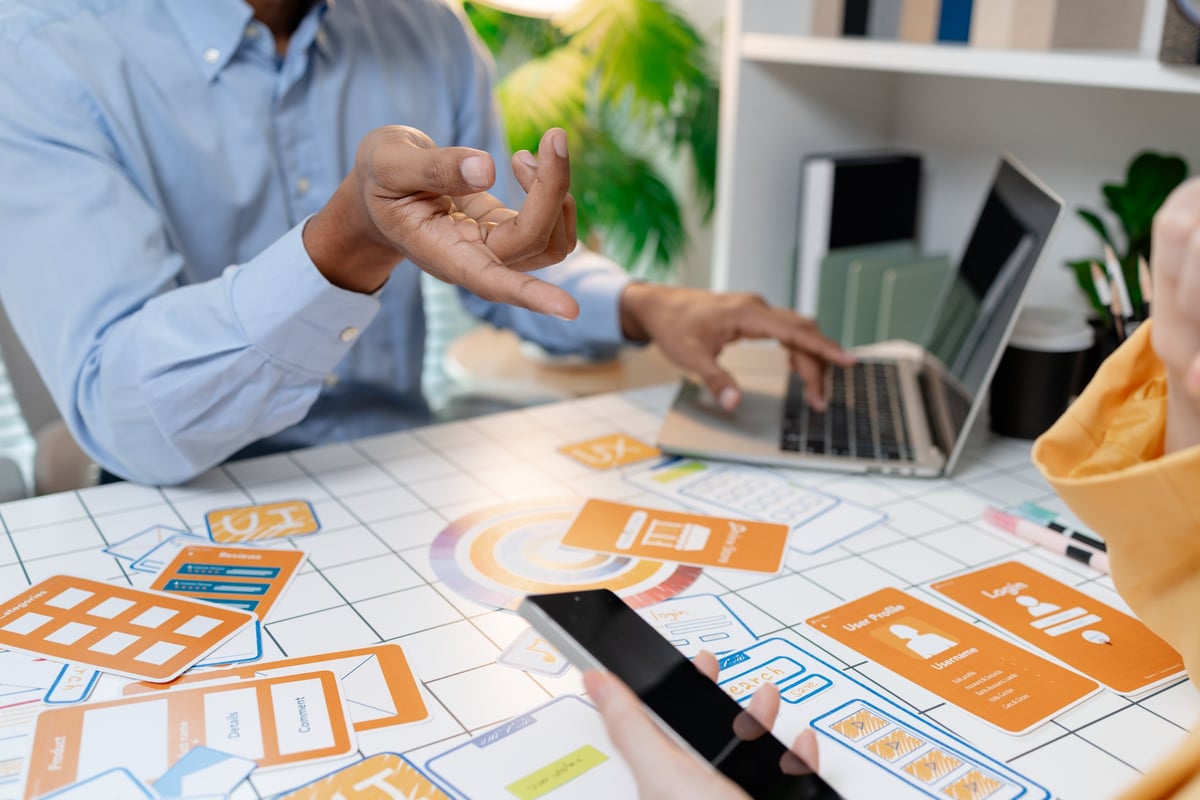 Designer presenting wireframes and interface layouts in a workshop